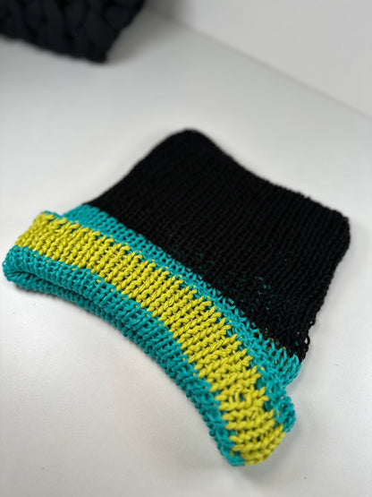 The black, turquoise, and lime green striped beanie